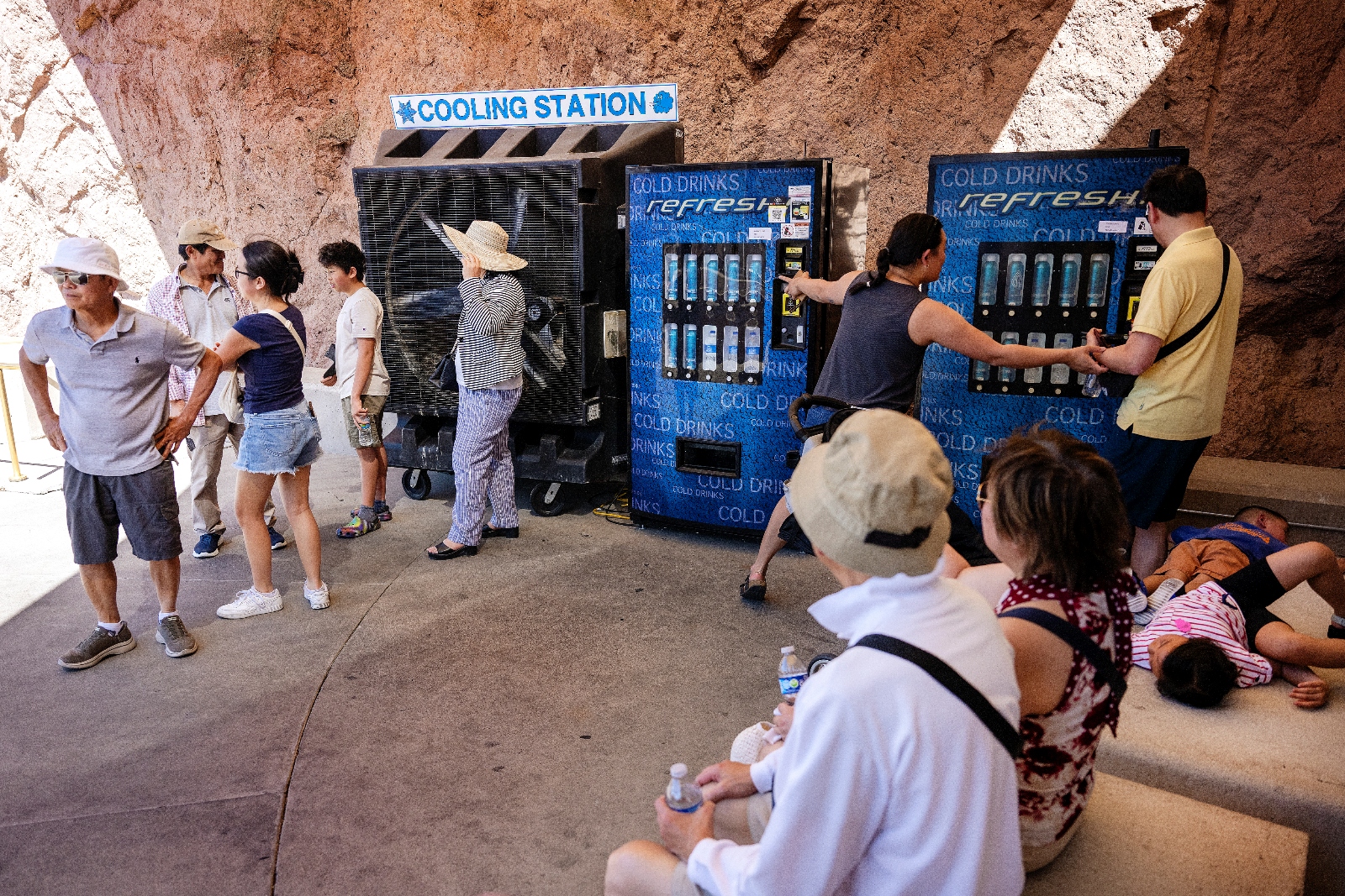 People standing in the shade at a cooling station at the Hoover Dam in Nevada