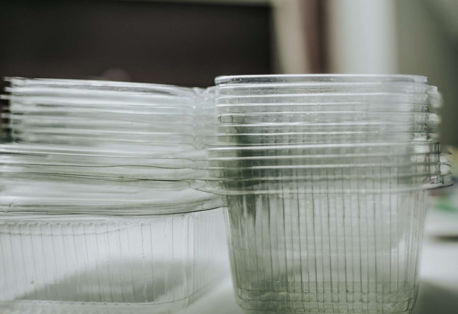 A stack of empty plastic containers on a shelf.