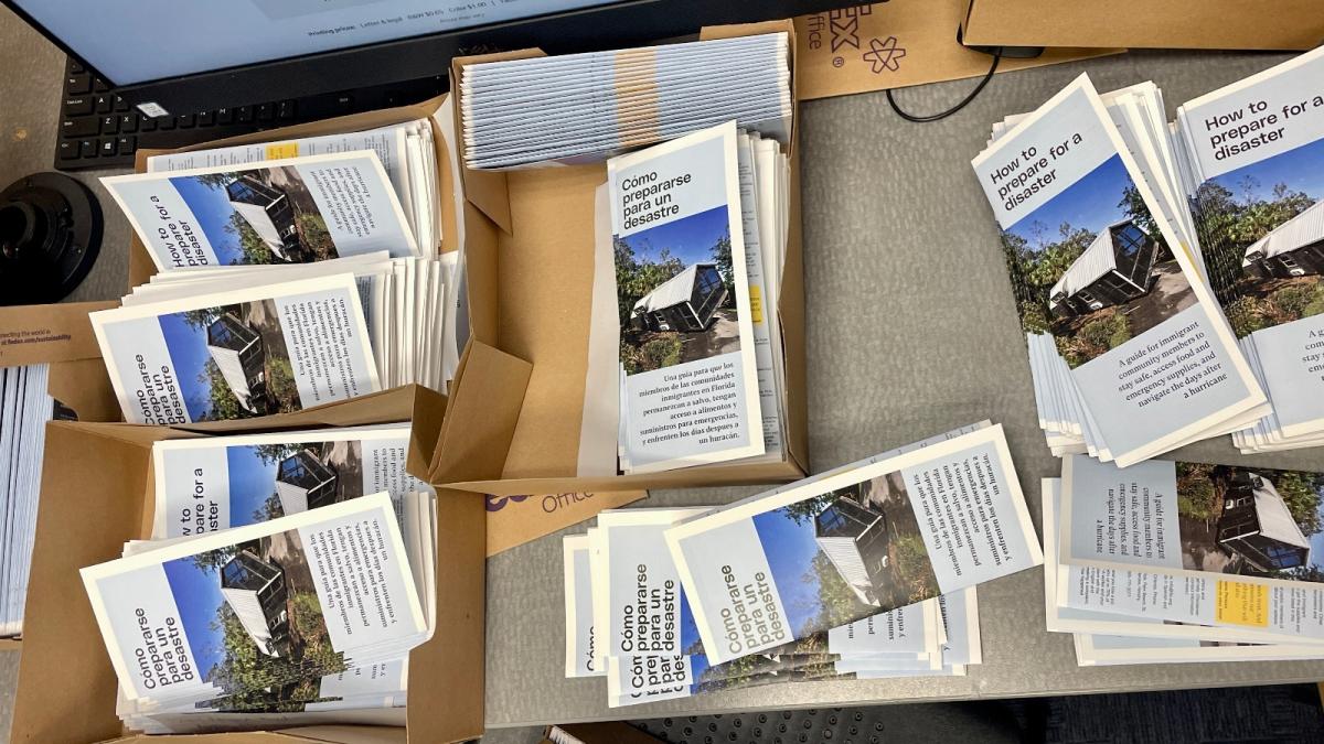 A series of brochures stacked on a table