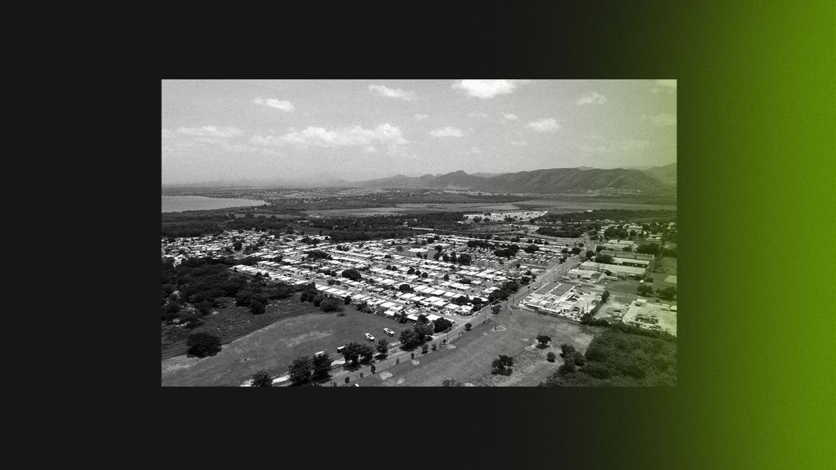 Black and white photo of Steri-Tech facility and Salinas homes with green fumes creeping in from edge of frame