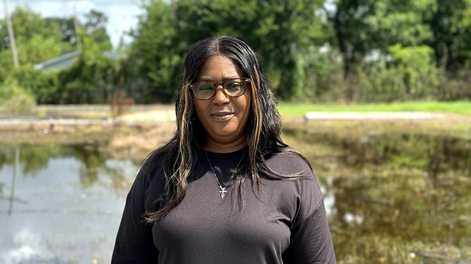 A woman in a black shirt poses for a portrait