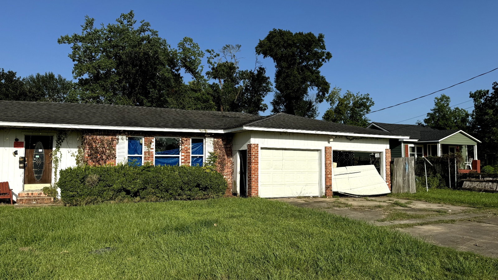 A brick house with green lawn