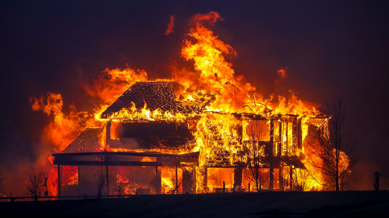 A house burns after the fast-moving Marshall Wildfire swept through Louisville, Colorado on December 30, 2021.