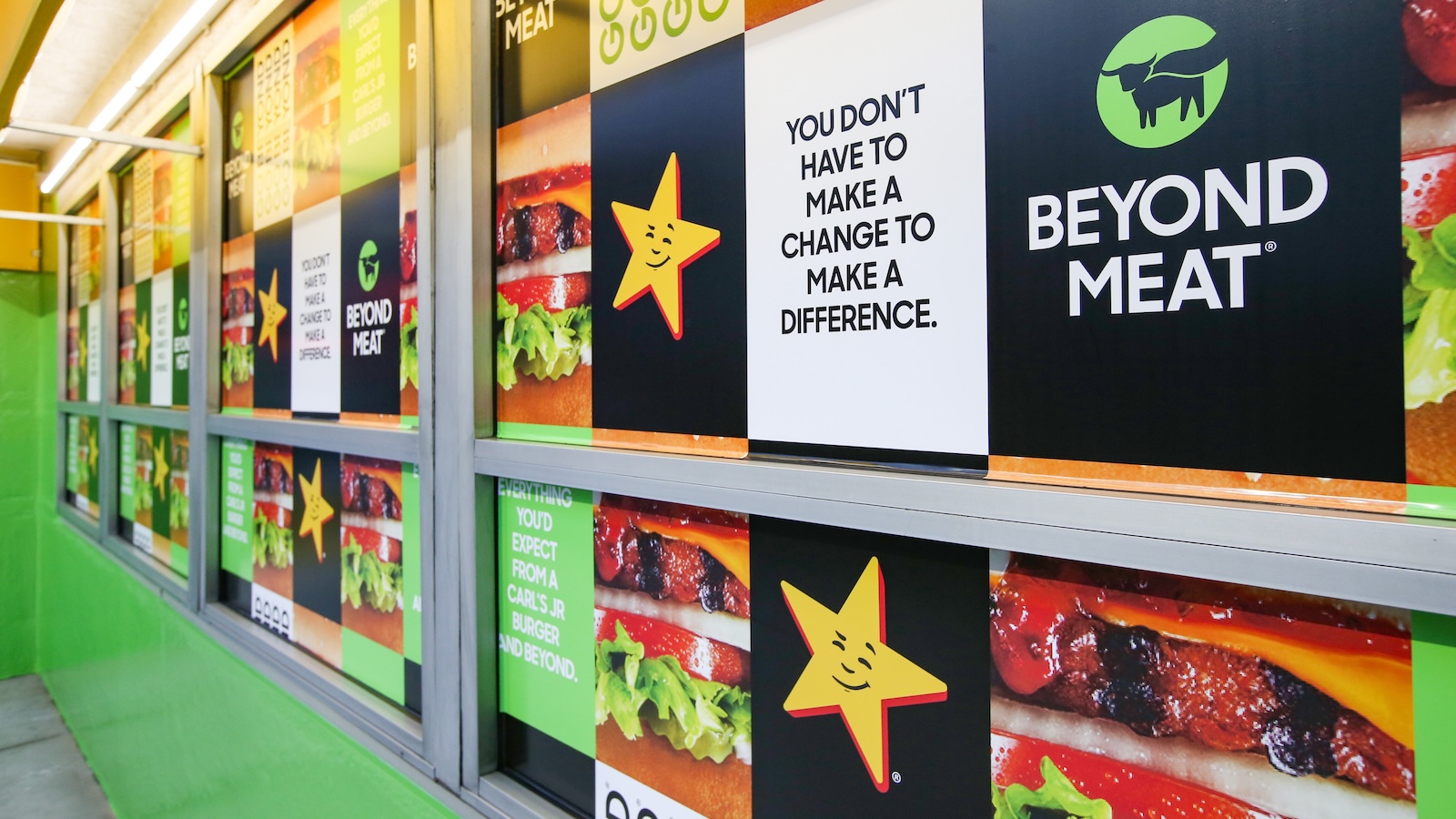 The exterior of a Carl's Jr. fast food restaurant was plastered in ads promoting a collaboration with Beyond Meat, with the tagline "You don't have to make a change to make a difference"