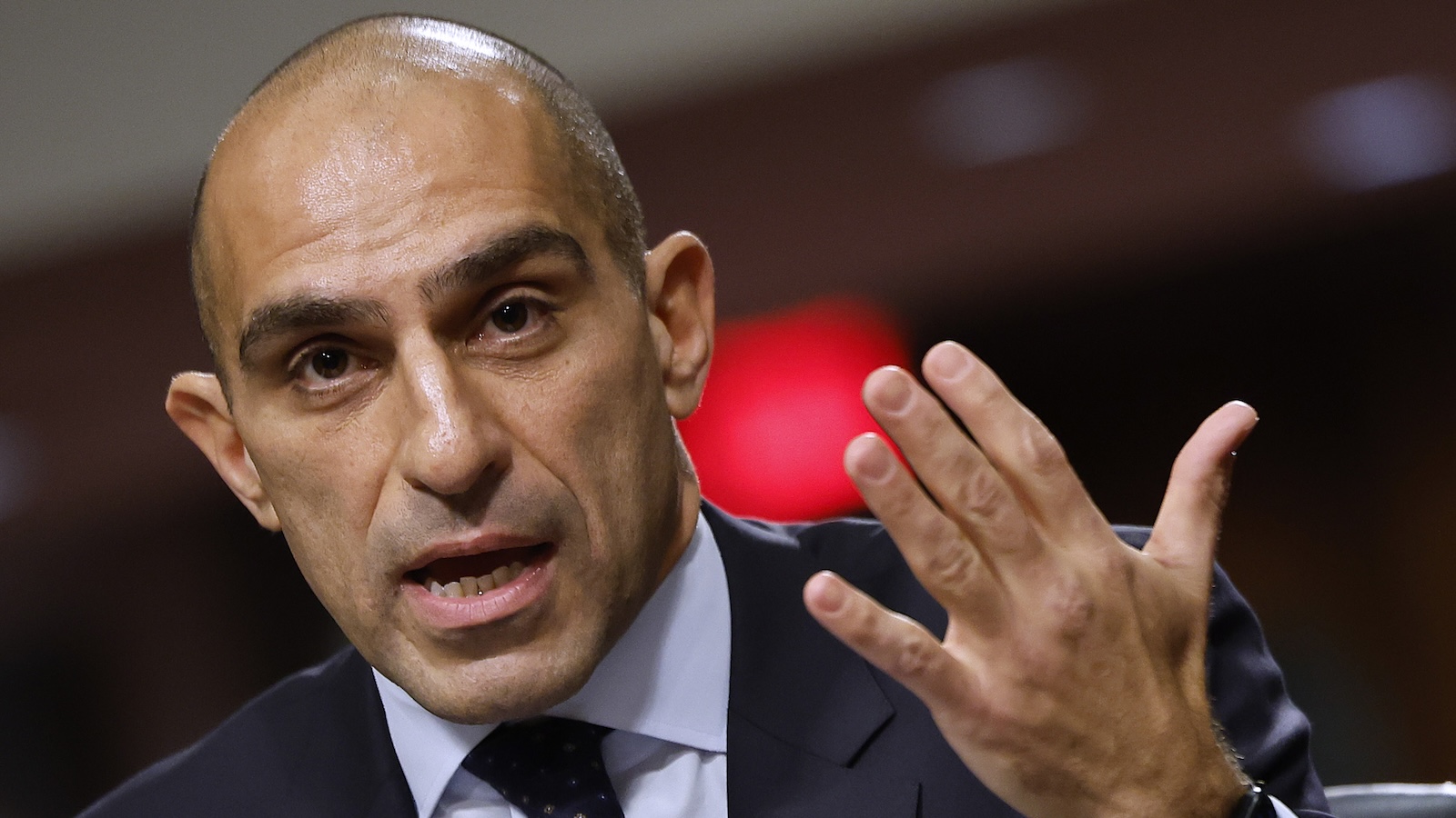 Close-up of CFTC Chair Rostin Behnam waving his hand.