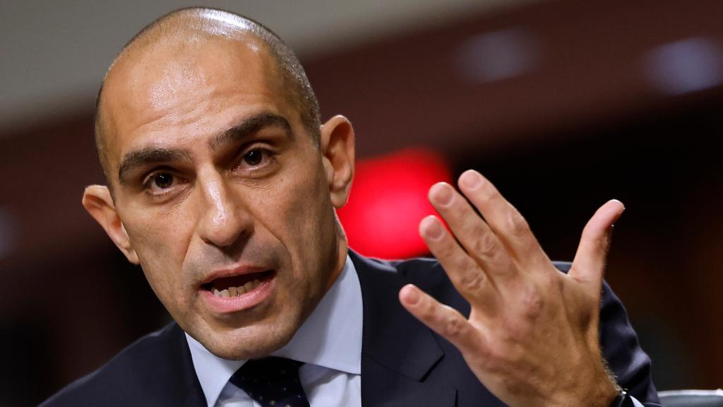 Close-up of CFTC Chair Rostin Behnam waving his hand.