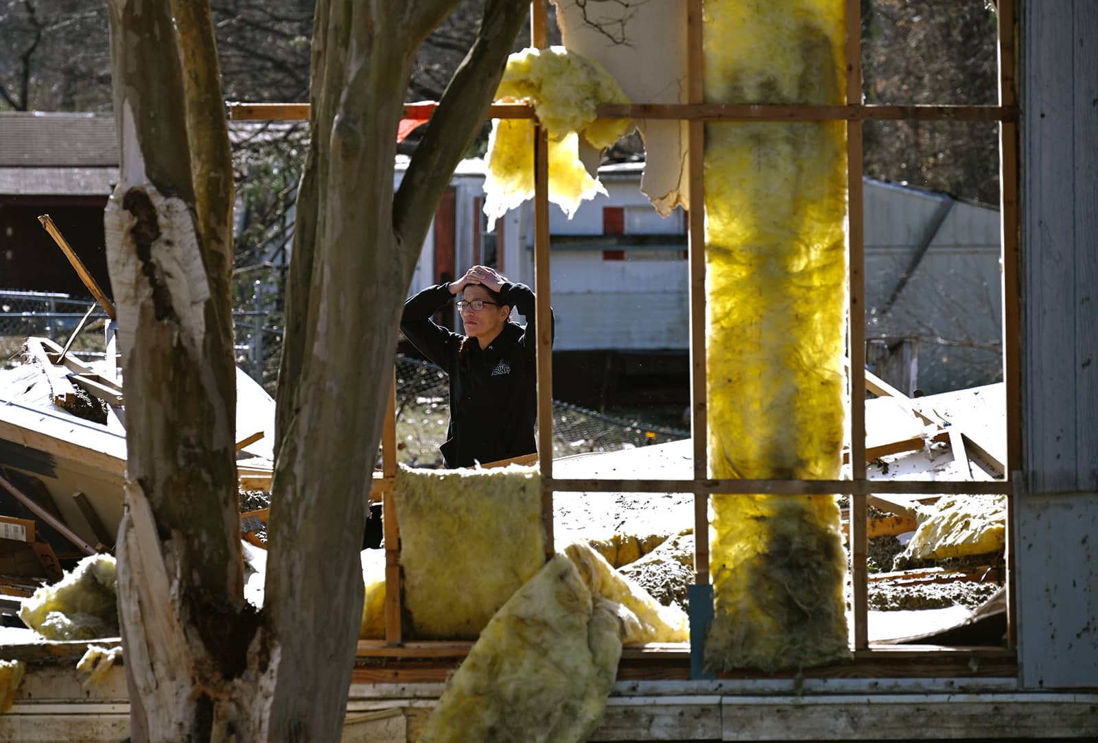 A person in Claremont, North Carolina, looks at damage from a large storm system