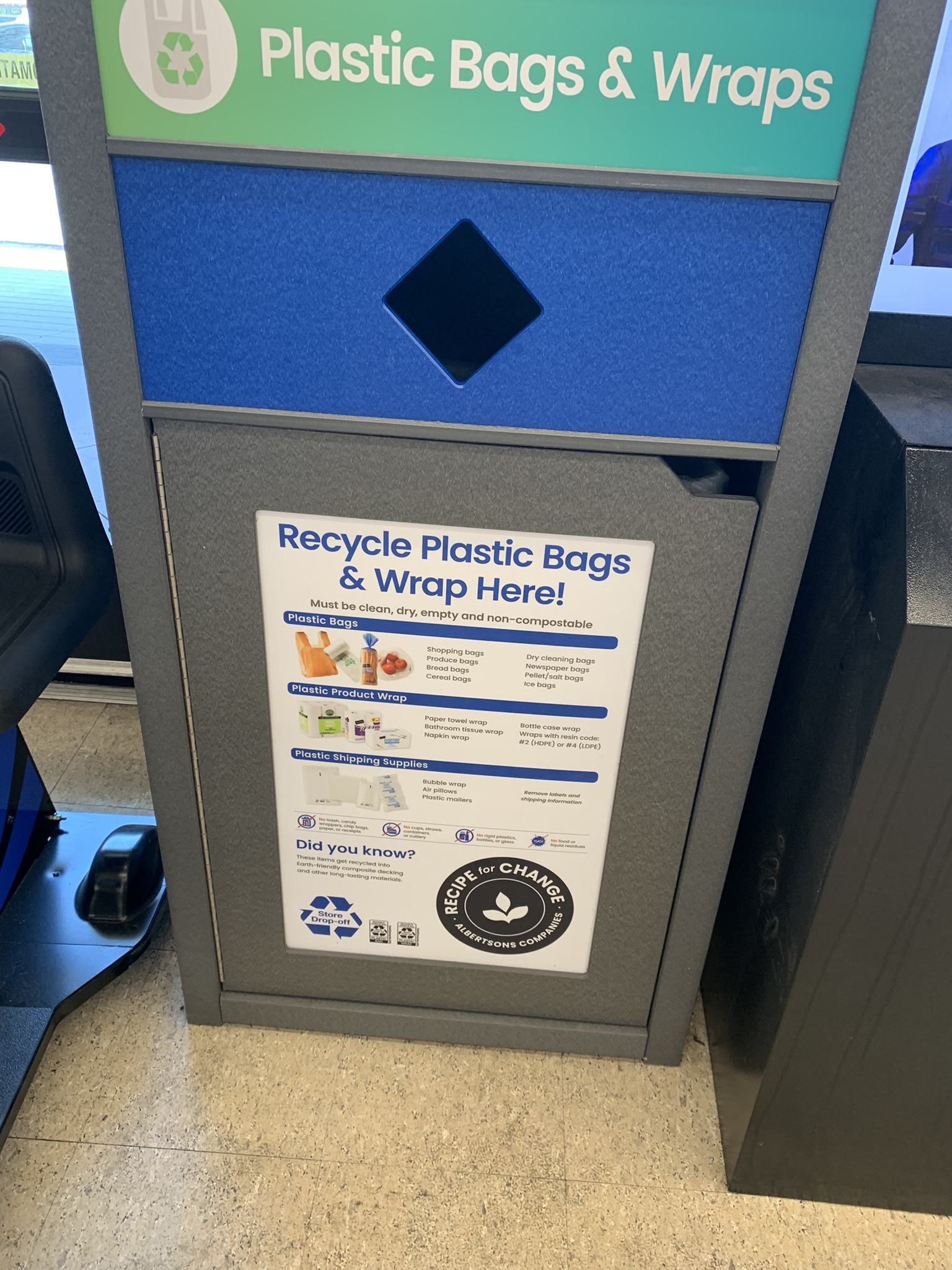 A blue, teal, and gray receptacle at a grocery store for people to return their plastic shopping bags.