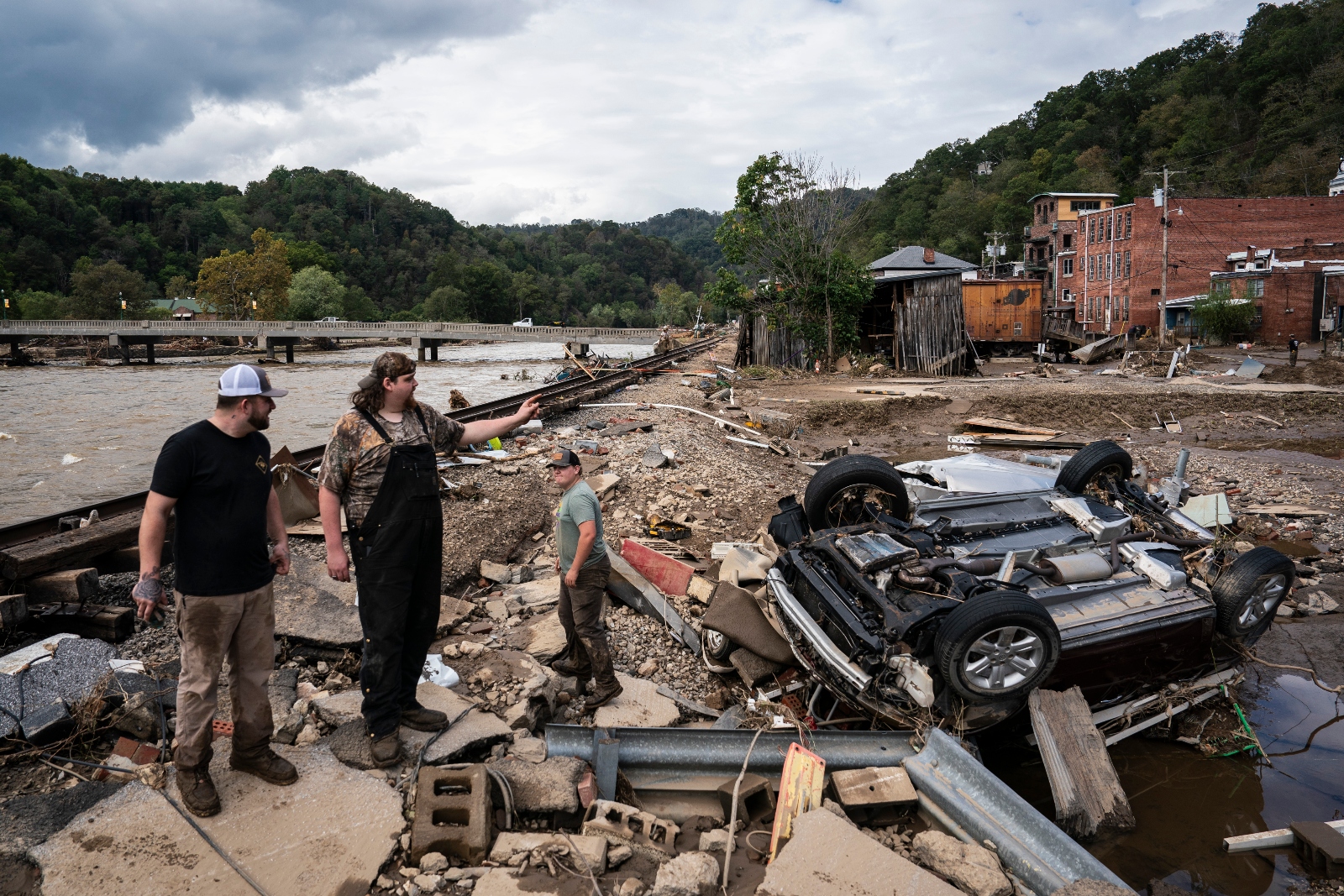 Residents of Marshall, North Carolina, search for missing items from a nearby mechanics shop in the aftermath of Hurricane Helene. The storm has likely shuttered dozens of polling places and destroyed thousands of absentee ballots.