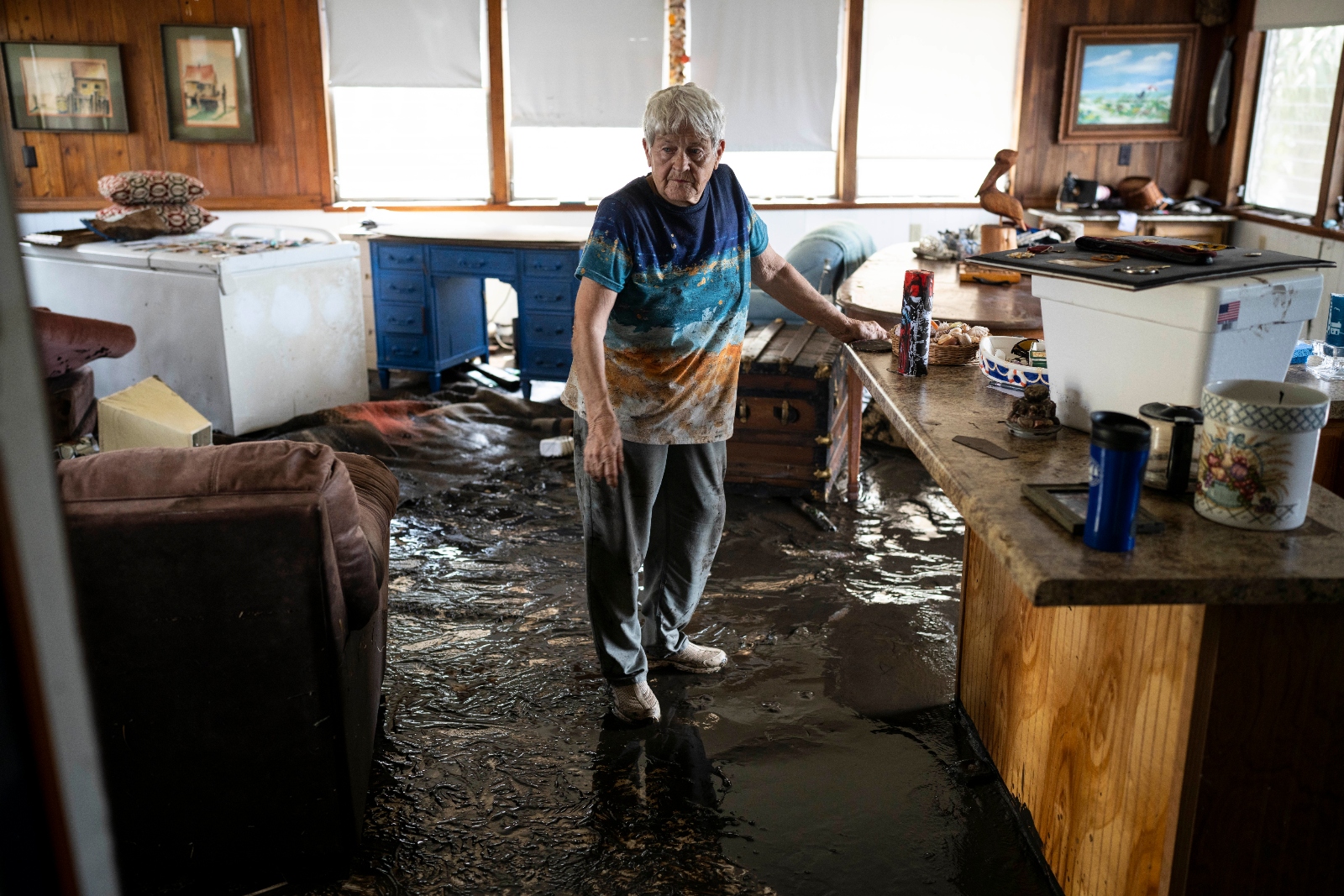 Bobbi Pattison examines flood damage to her home in Steinhatchee, Florida, after Hurricane Helene struck the town in August 2023.