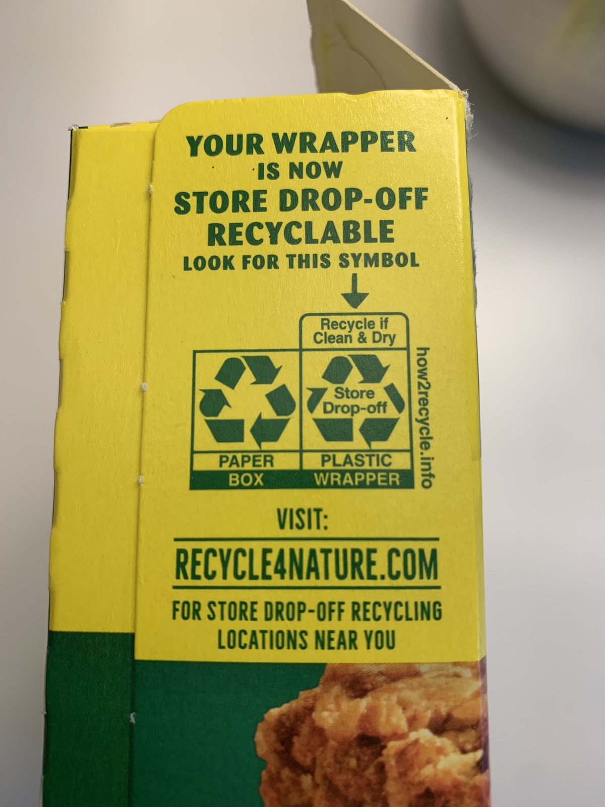 The side of a yellow box reads Your wrapper is now store drop-off recyclable, and has the darts recycling symbol.