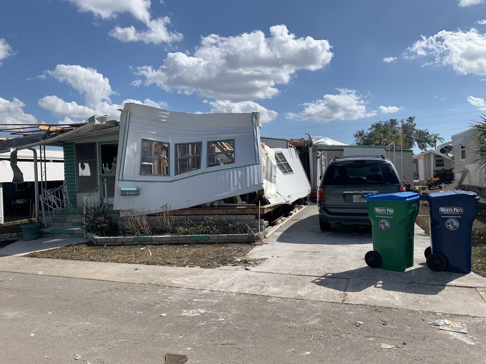 A mangled mobile home with twisted siding