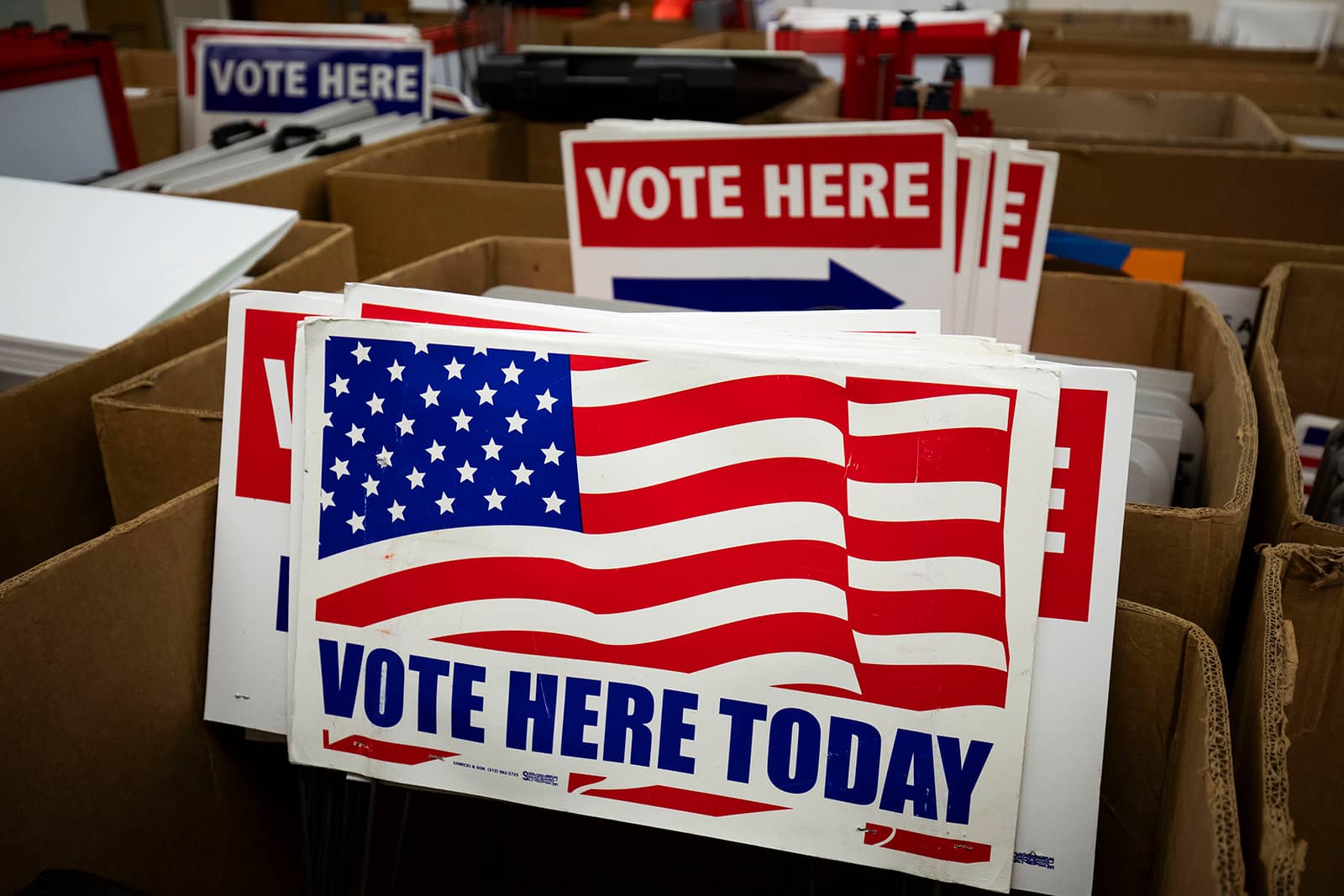 Cardboard boxes with red and blue voting signs