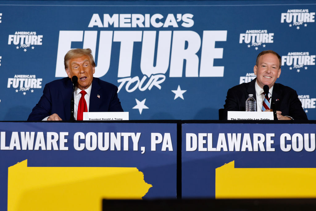 Donald Trump and Lee Zeldin stand side by side at lecterns