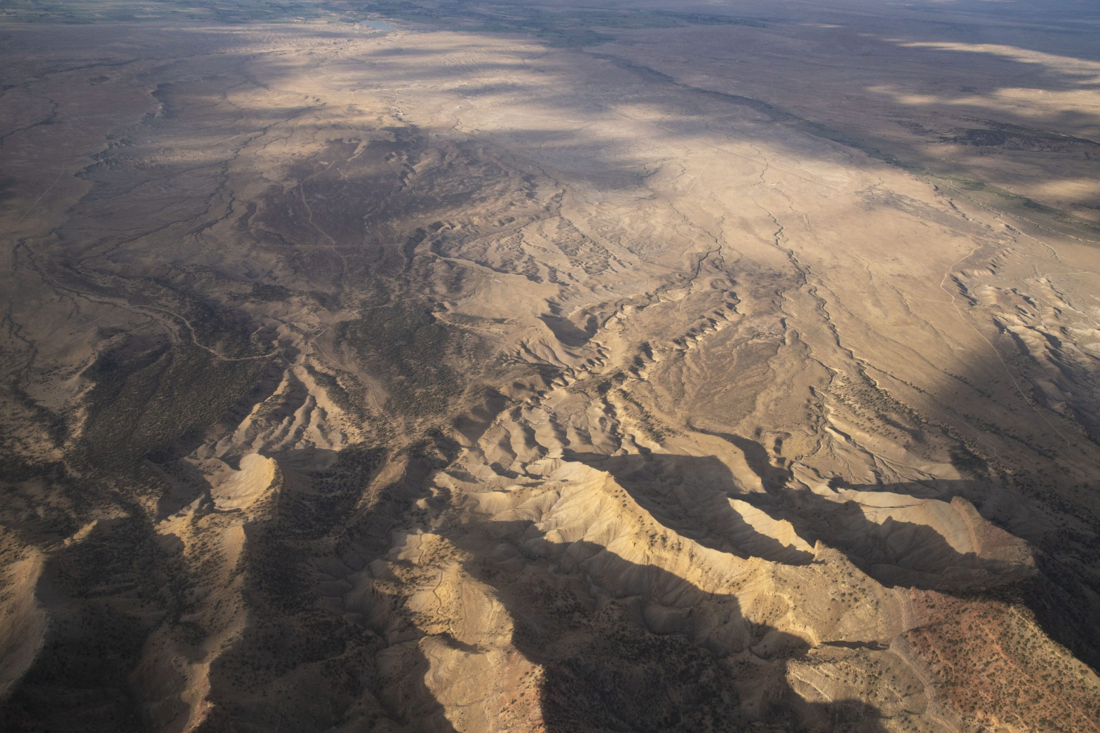 An aerial image of a brown and yellow desert