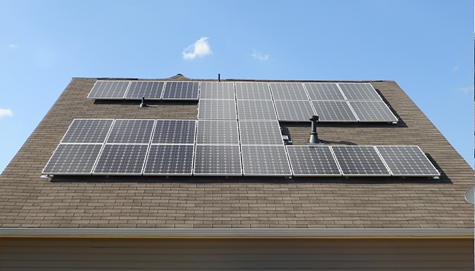 A slate of solar panels on a roof