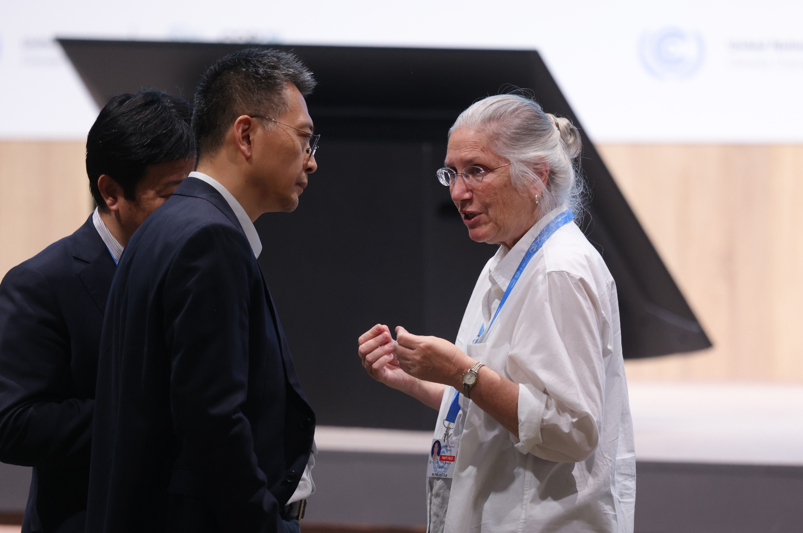 Sue Biniaz, the lead United States climate negotiator, speaks with another delegate on the plenary floor at COP29. Biniaz, a longtime presence at climate talks, helped save a climate finance deal from collapsing in Baku.