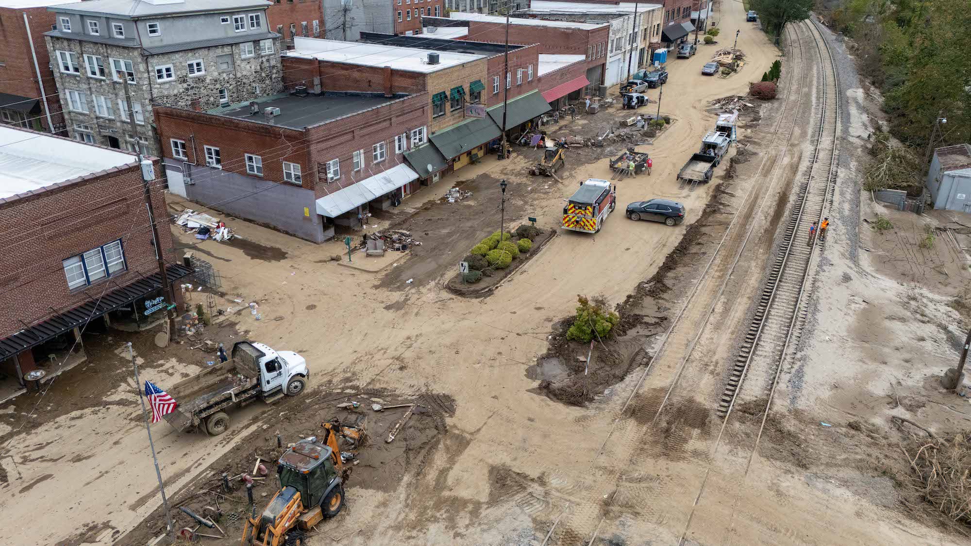 An aerial shot of a storm-damaged downtown covered in mud