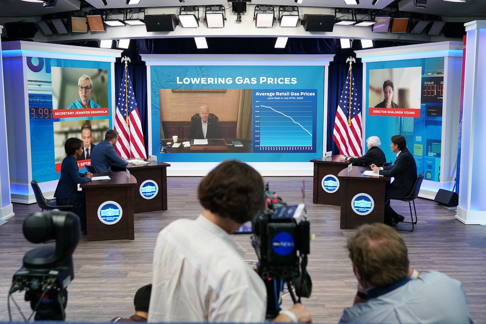 A studio with camera facing a screen with Biden and a heading that says 'lowering gas prices'