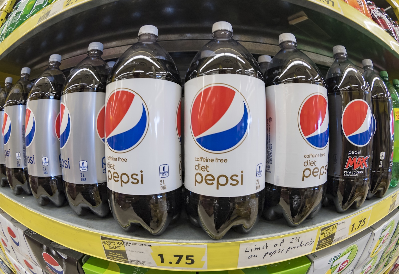 Diet Pepsi bottles on a shelf, viewed with a fish eye lens.