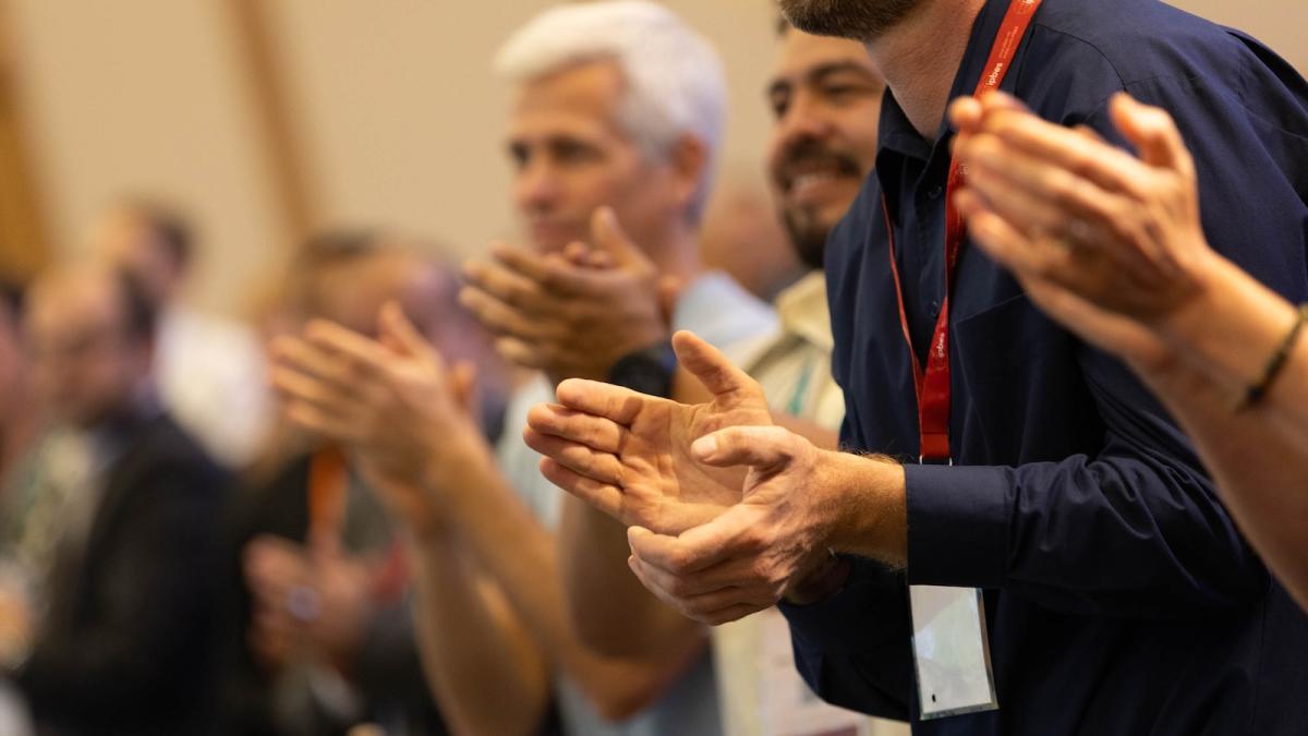 Close-up of people's hands as they applaud