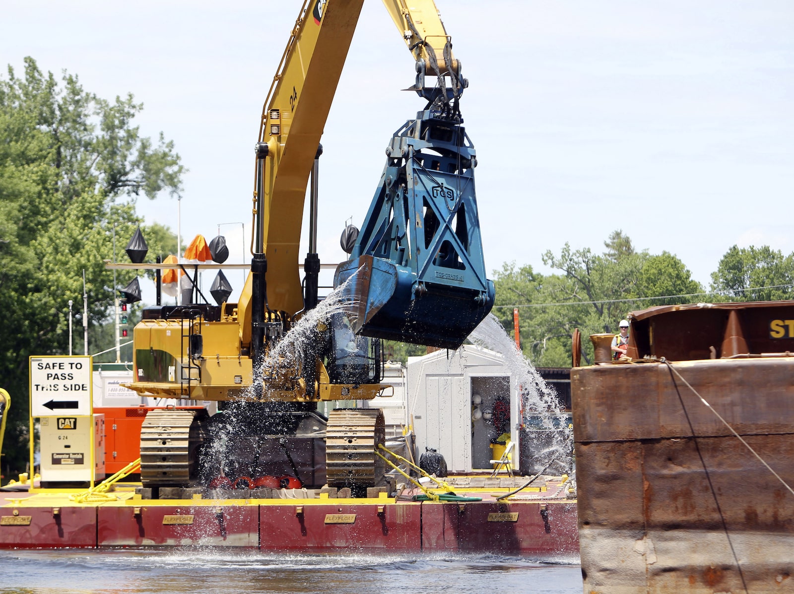 A large piece of equipment dredges a river