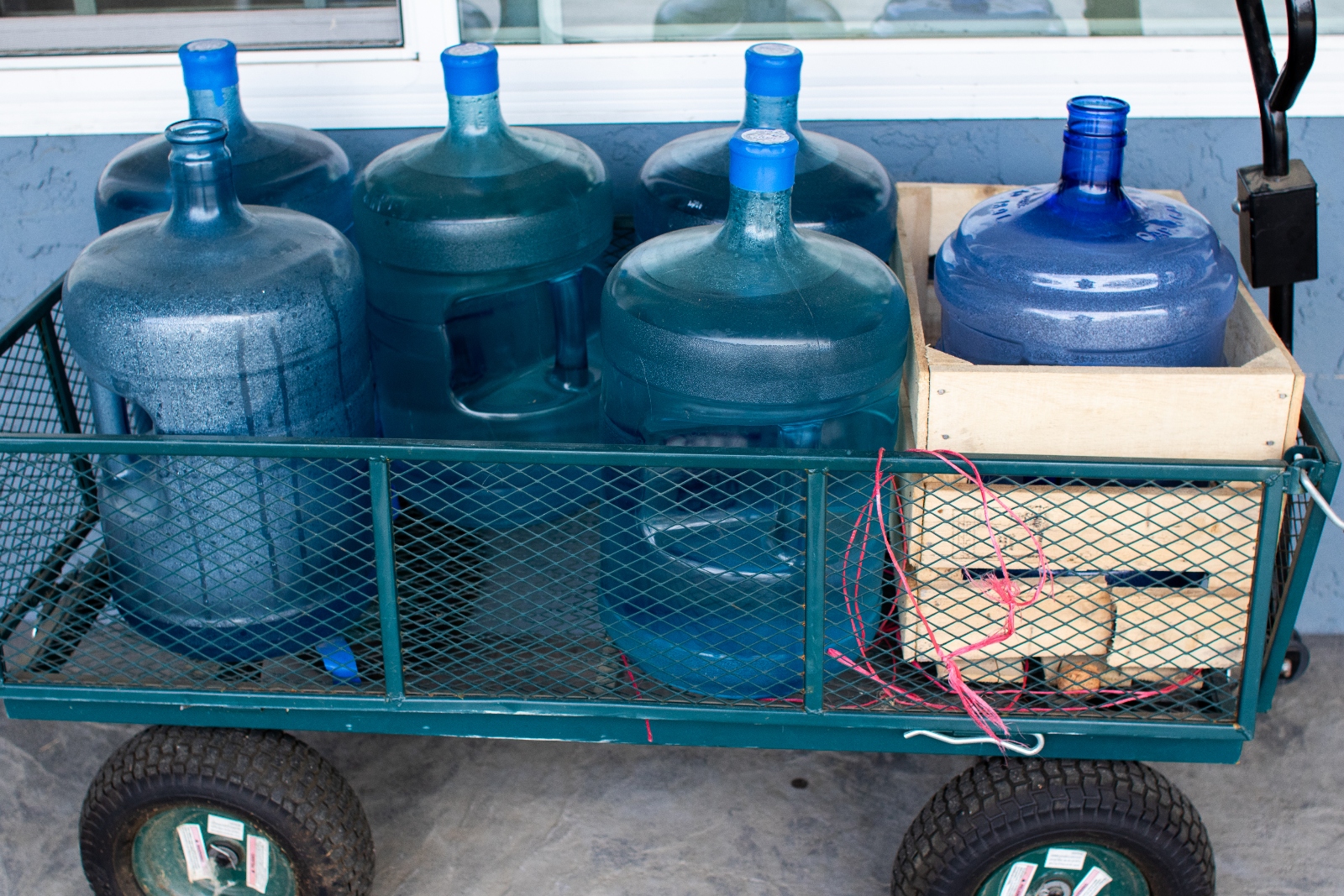 Multi-gallon water bottles are seen in wagon