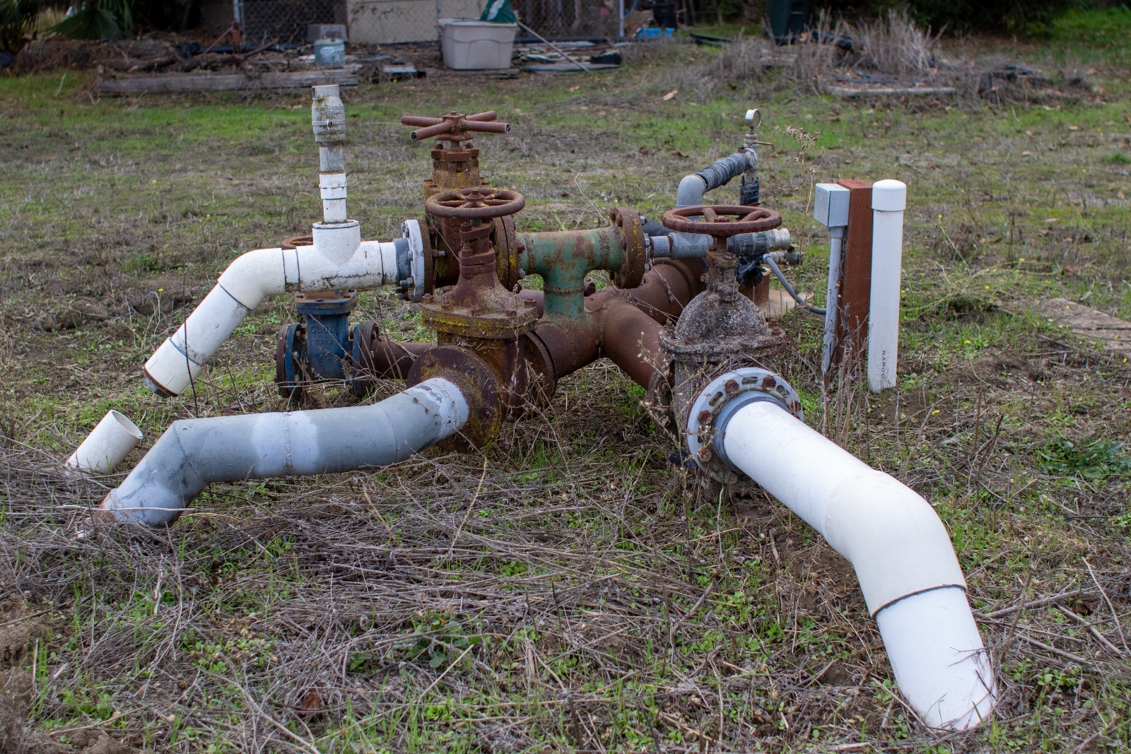 Pipes from a water well intersect aboveground