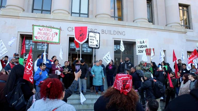 Farmworkers and their advocates wave pickets on the steps of the Capitol in Olympia, Washington