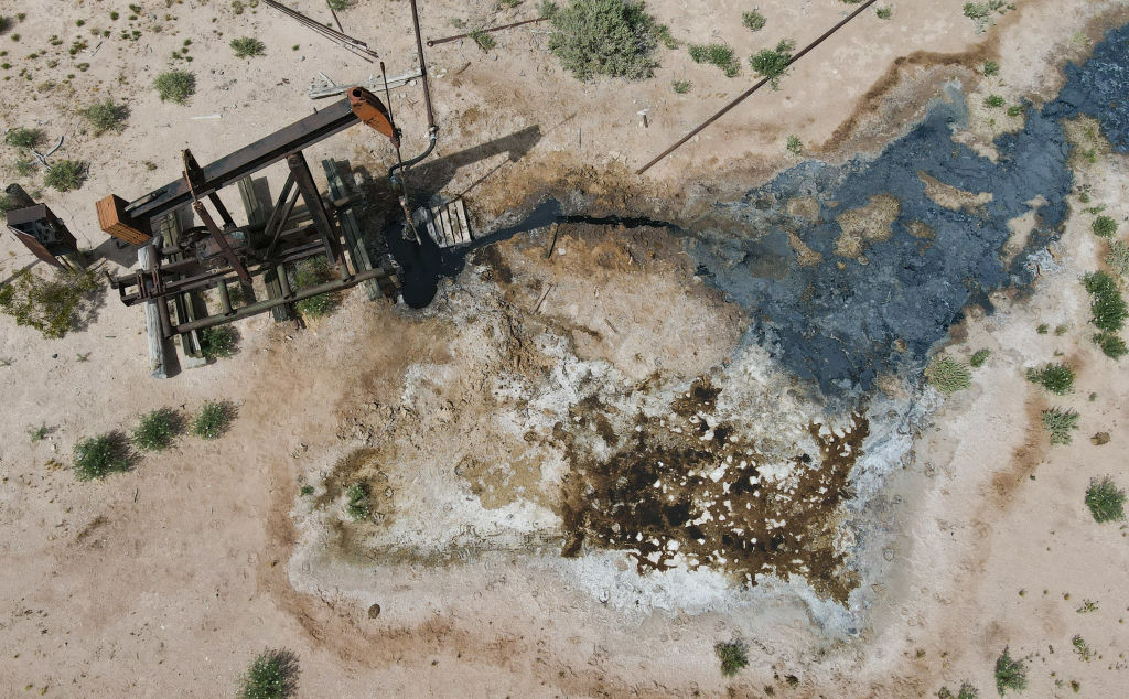 Aerial image of a leaky, decrepit oil well