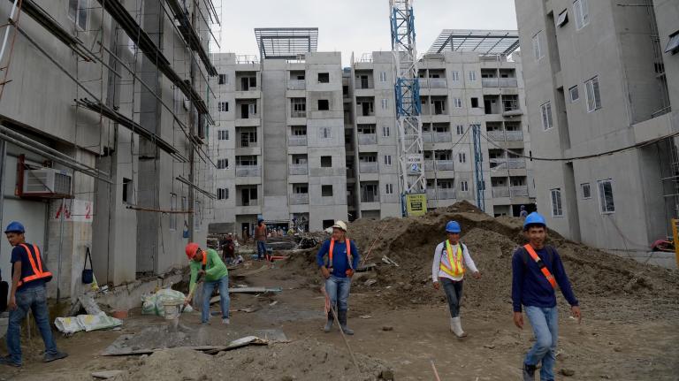 A construction crew erects concrete buildings in New Clark City, a climate-resilient city the Philippine government is building north of Manila.