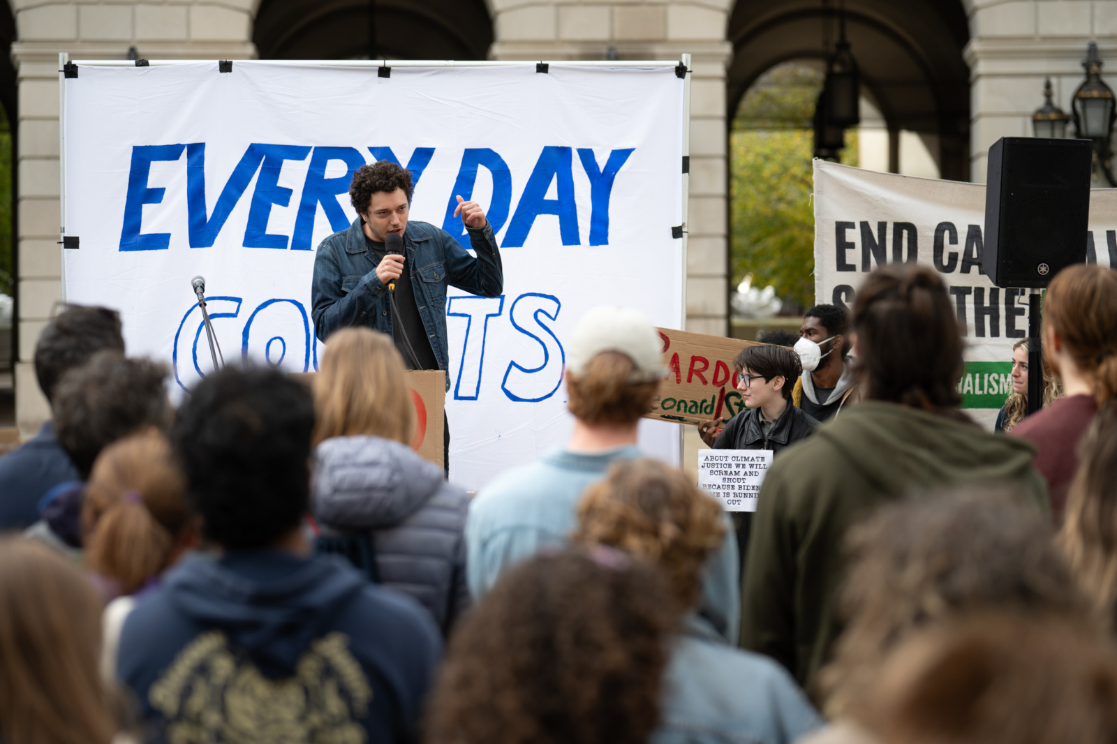 Photo of a crowd of people gathered in front of a speaker