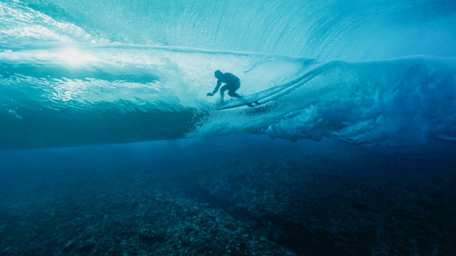 French surfer Joan Duru is glimpsed through the waves while competing in the 2024 Olympic Games in in Teahupo'o, French Polynesia.