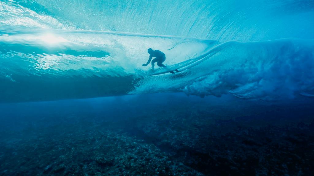 French surfer Joan Duru is glimpsed through the waves while competing in the 2024 Olympic Games in in Teahupo'o, French Polynesia.