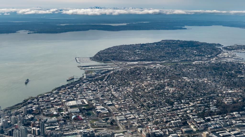 Aerial view of Puget Sound and city of Seattle, with mountains in background