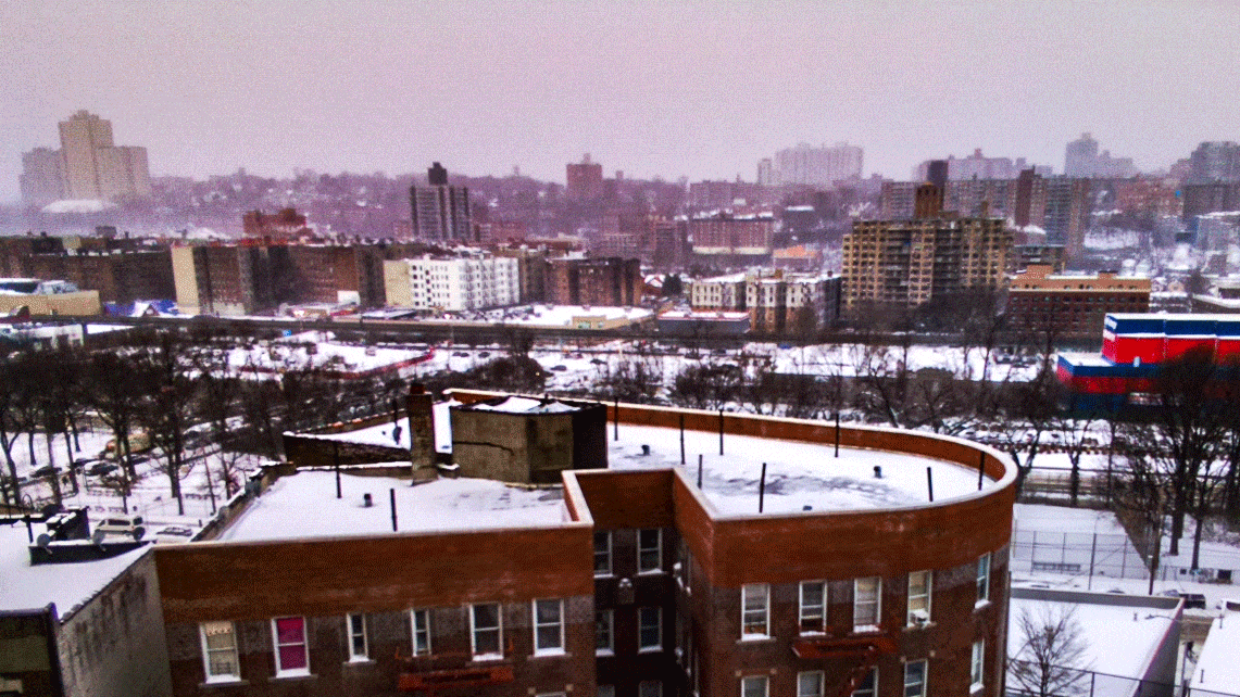 A moving cityscape shows buildings covered in snow