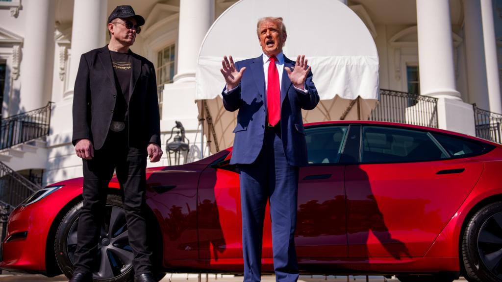 Photo of Trump and Musk standing in front of the White House by a red Tesla