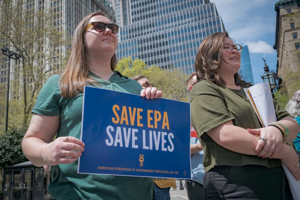 Two people participating in a rally for the Environmental Protection Agency.