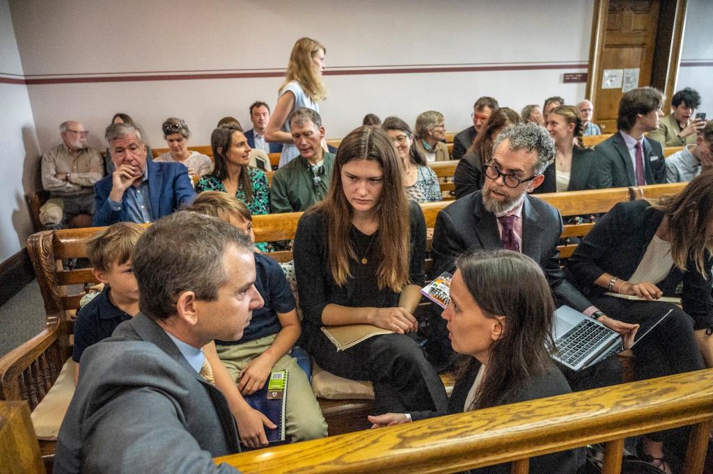 Young plaintiffs confer with their lawyers in a courtroom in Montana.