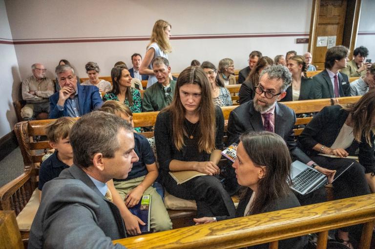 Young plaintiffs confer with their lawyers in a courtroom in Montana.