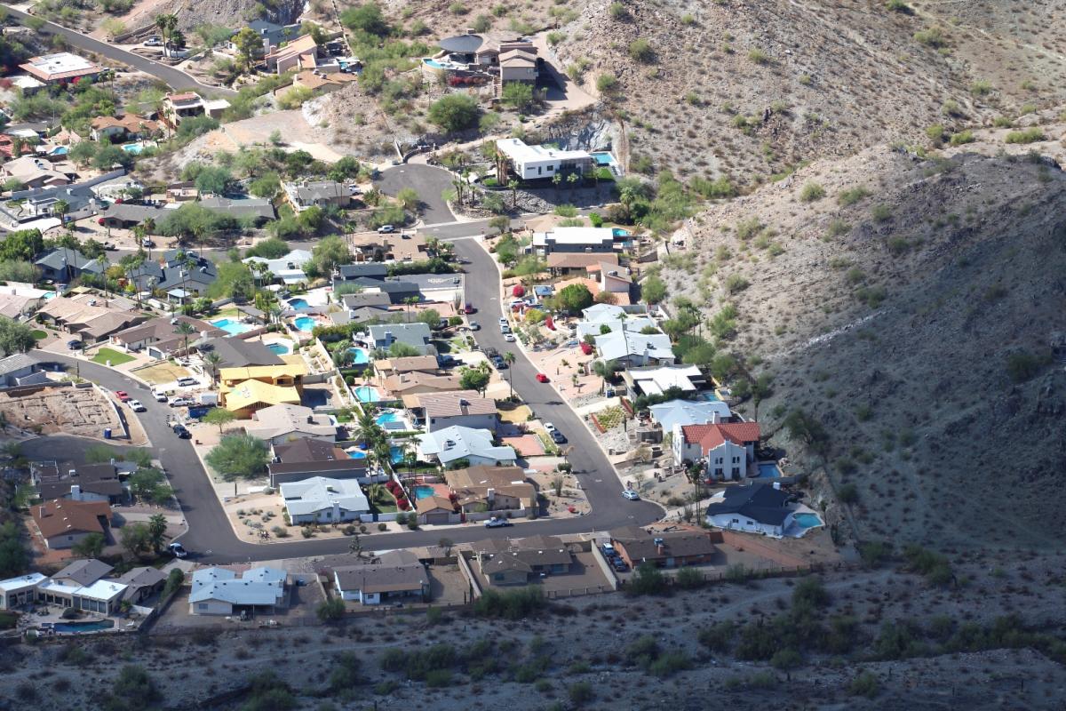 An aerial view of houses in the desert landscape of Phoenix