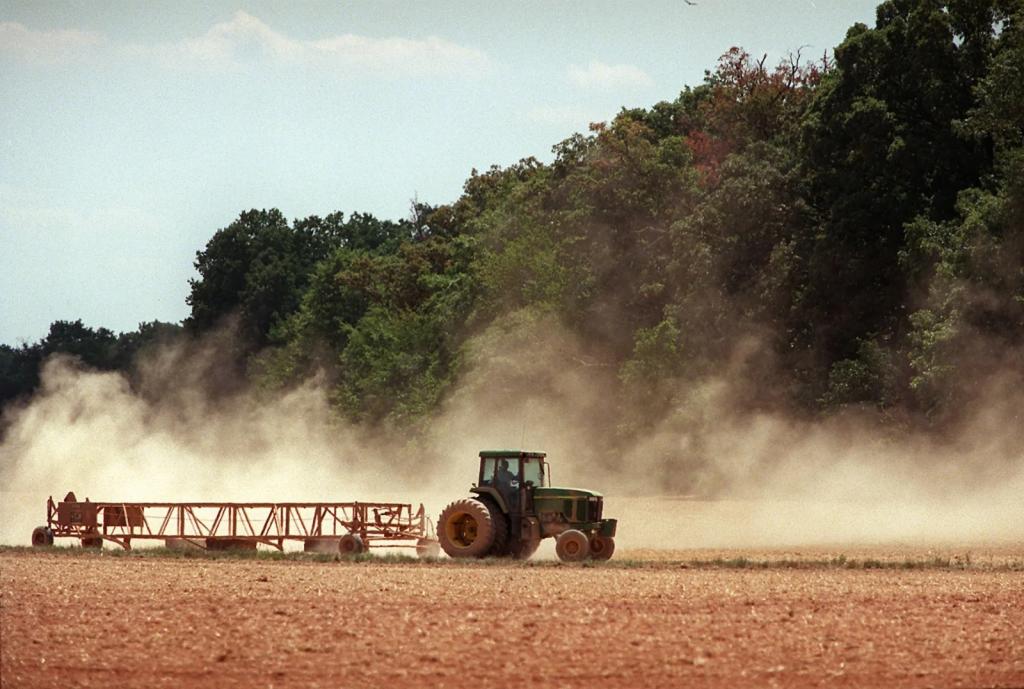 A tractor in a dusty field