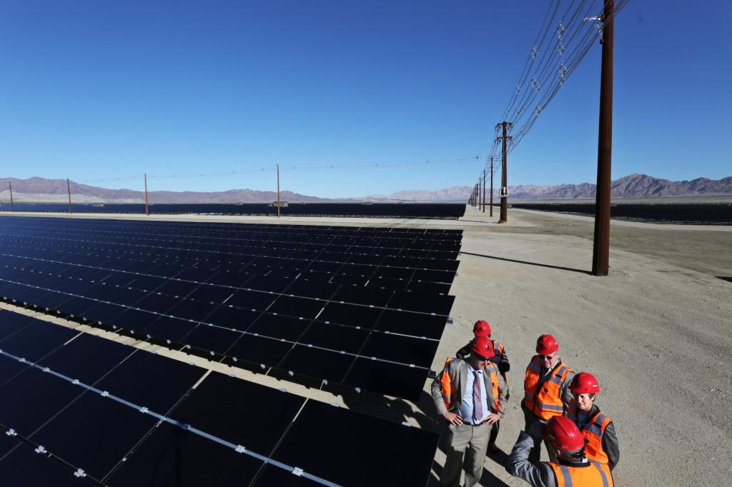Former United States Department of Interior Secretary Sally Jewell, right, tours the new 550-megawatt Desert Sunlight Solar Farm with officials during a dedication ceremony for the facility on February 9, 2015 in Desert Center, California.