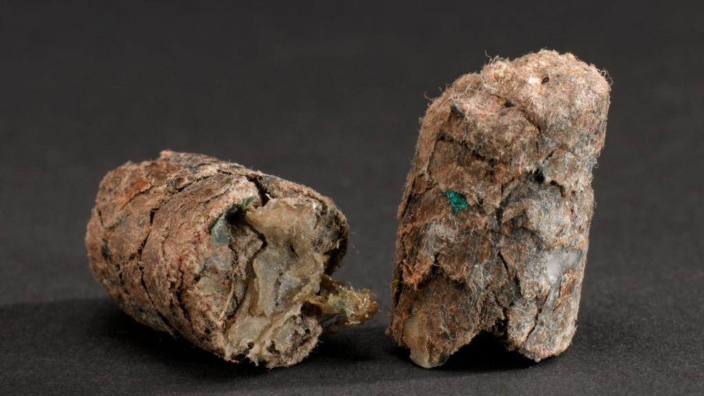pellets of compacted plastic trash on a black background