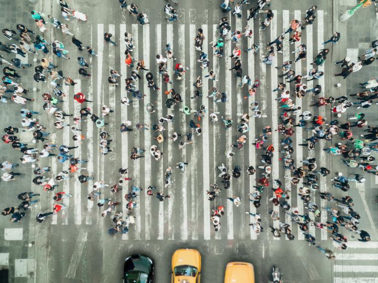 A birds-eye view of a crowded crosswalk in New York City.