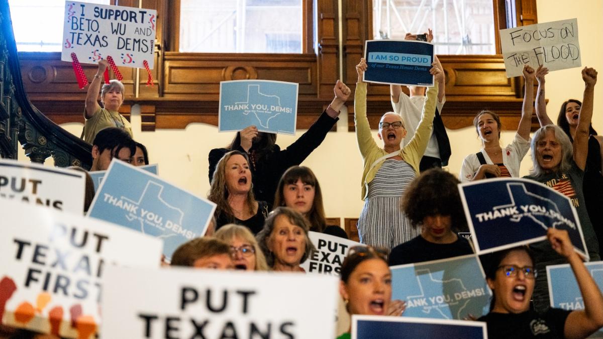 Demonstrators chant as lawmakers are welcomed back ahead of a House meeting in the state Capitol in Austin, Texas.