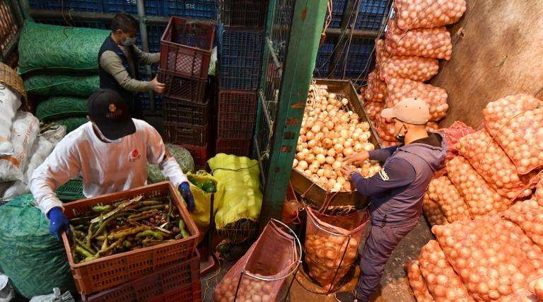 men pack up boxes of food for a food bank