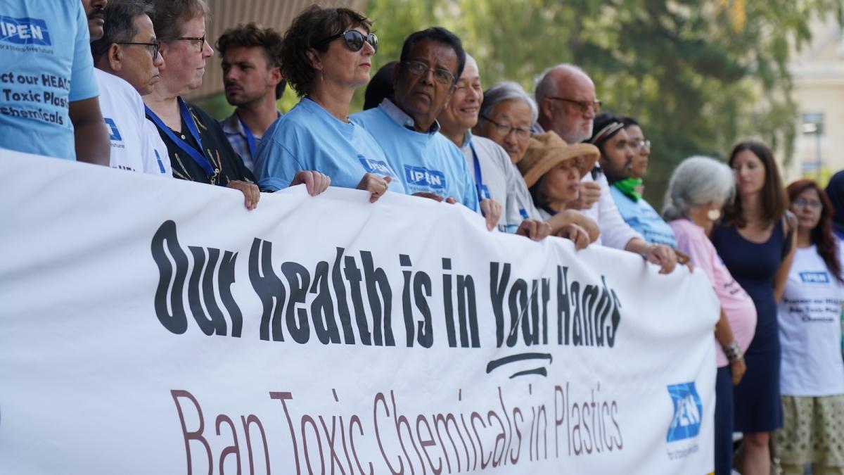 Protesters hold a banner reading, "Our health is in your hands: Ban toxic chemicals in plastics."