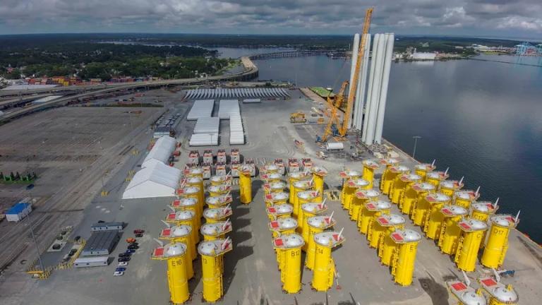 An aerial view of an industrial yard next to a river