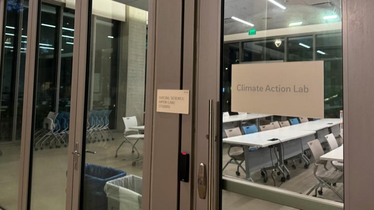 A set of glass doors that say Climate Action Lab